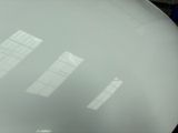 three windows on the side of a large white object