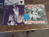 a lot of records on a table with a person standing next to them