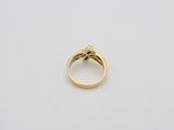 a close up of a gold ring on a white surface