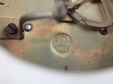 a close up view of a clock with a metal face