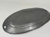 a metal tray with a lid on a white table