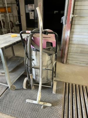 a picture of a vacuum and a cart in a garage