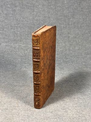 an old book with a wooden cover sitting on top of a table
