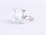 a close up of a ring with an aquamarine stone on a white background
