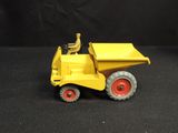 a yellow toy dump truck with a man sitting in it