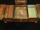 a small wooden table with a mirror on top of it
