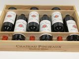 bottles of red wine in a wooden box on a table