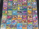 a table topped with lots of different pokemon cards on top of each other