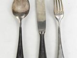 three forks, a spoon, and a knife on a table