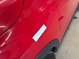 a red car with a sticker on the side of it