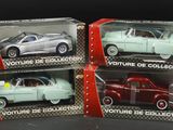 three toy cars are in a box on a black surface