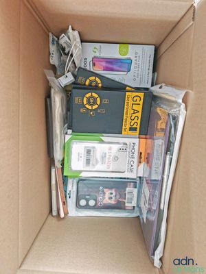 a cardboard box filled with electronic devices and other items