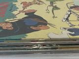 a stack of comic books sitting on a table