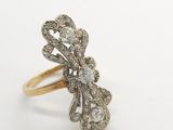 a gold and diamond ring on a white background
