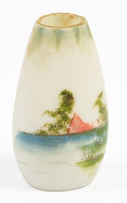 a white vase with a picture of a house on it