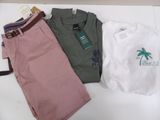 three pairs of shorts and a t - shirt sitting on a table