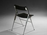 black leather folding chair with chrome legs and a black seat