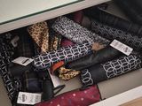 many umbrellas that are sitting in a drawer