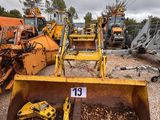 a lot of construction equipment that are sitting in the dirt