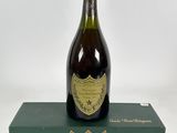 a bottle of champagne sitting on top of a green box