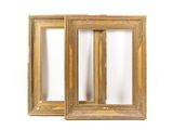 a pair of antique gold picture frames on a white background