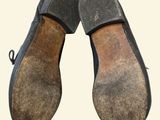 pair of black shoes with brown soles on a white background