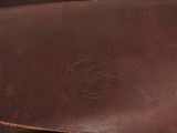 brown leather case with a logo on it sitting on a table