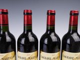 three bottles of wine are lined up on a table