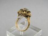 an image of a gold and diamond ring sitting on top of a clear display case