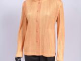a mannequin mannequin wearing an orange shirt and black pants