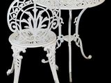 a white table and two chairs on a black background