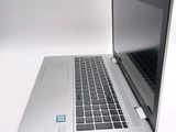 a silver laptop with a blue sticker on the screen