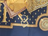 a blue and gold table cloth with a gold cross on it