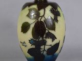 a vase with leaves on it sitting on a table