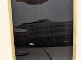 a reflection of a person in a mirror of a surfboard
