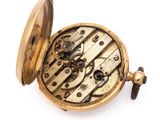 a gold pocket watch with a chain on it