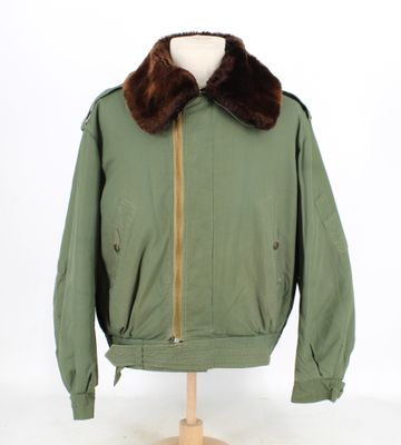 an image of a green jacket with a fur collar on a mannequin stand