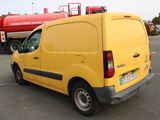 a yellow van that is parked in a parking lot