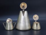 three metal objects that are sitting on a table