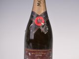 a close up of a bottle of champagne on a white surface