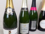 several bottles of champagne are lined up next to a pair of scissors