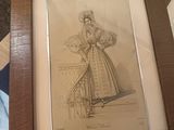 a drawing of a woman in a dress on a table
