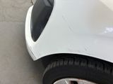 a close up of a car ' s front bumper and tire