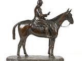 bronze statue of a man on a horse on a white background