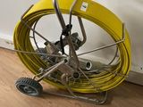 a yellow hose that is sitting on a cart