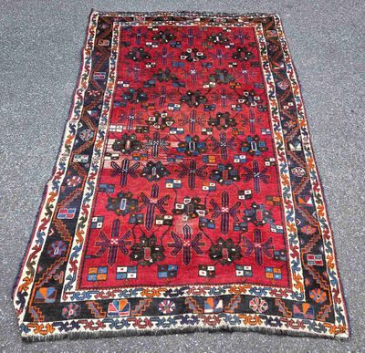 a red and blue rug with a pattern on it