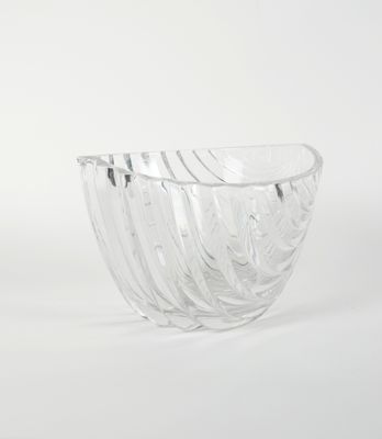 a clear glass bowl that is sitting on a white surface