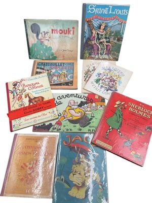 several children ' s books are lined up on a white surface