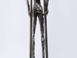 a statue of a man holding a pair of skis