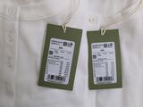 two tags on a white shirt that are attached to the back of the shirt